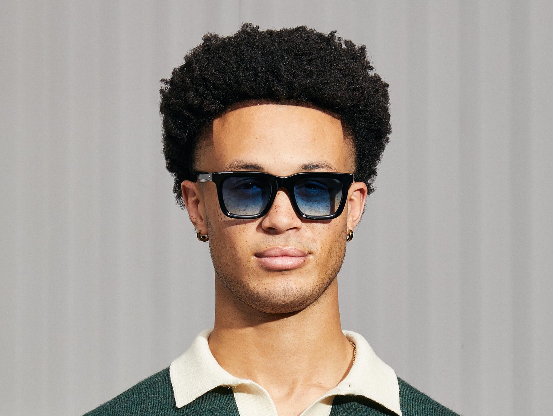 Model is wearing The RIZIK in Black in size 49 with Broadway Blue Fade Tinted Lenses