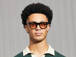 Model is wearing The RIZIK in Black in size 49 with New York Rose Tinted Lenses