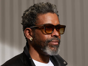 Model is wearing The RIZIK SUN in Olive Brown in size 49 with Chestnut Fade Tinted Lenses