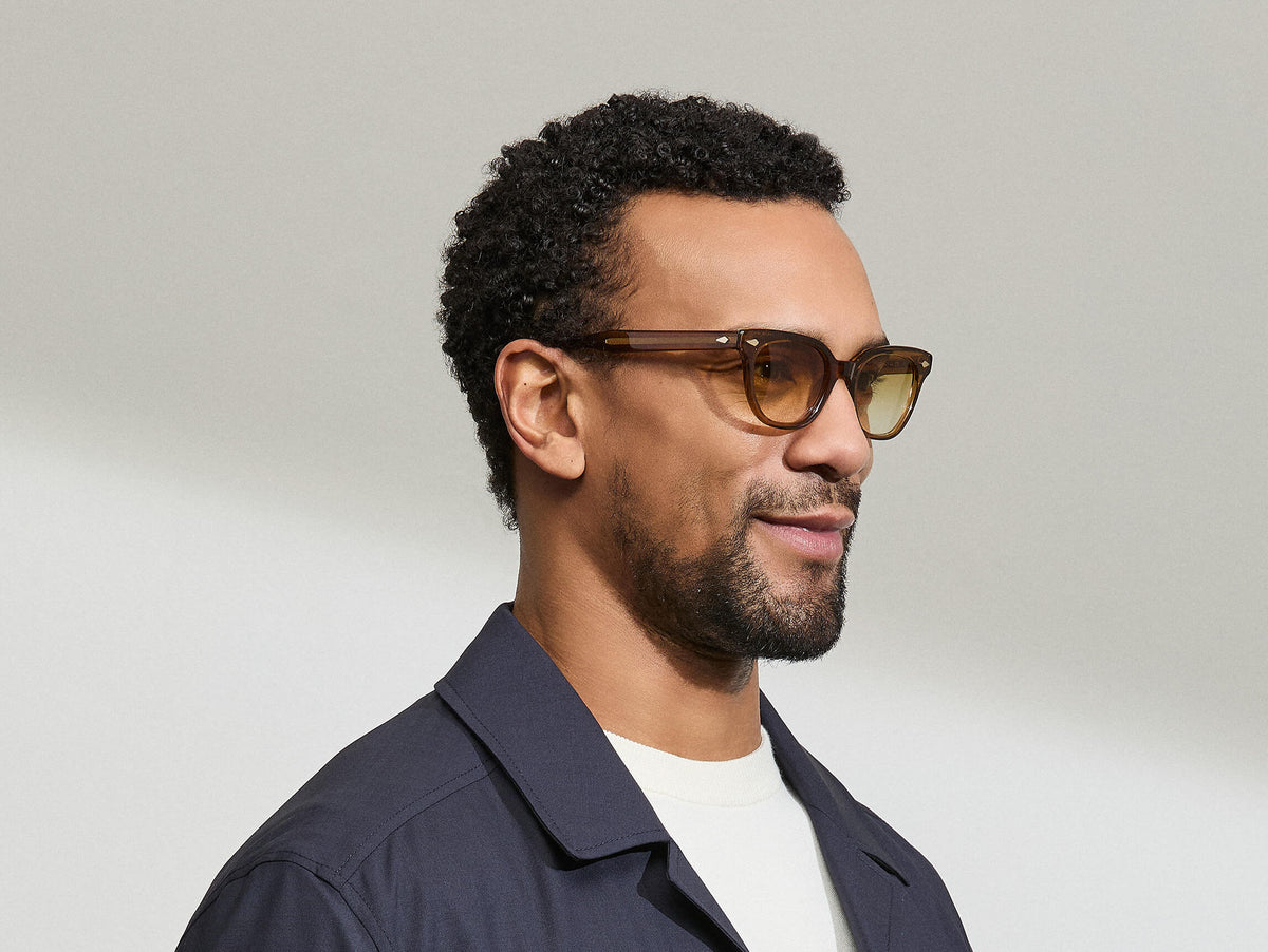Model is wearing The SHANEKITE SUN in Cognac in size 49 with Chestnut Fade Tinted Lenses