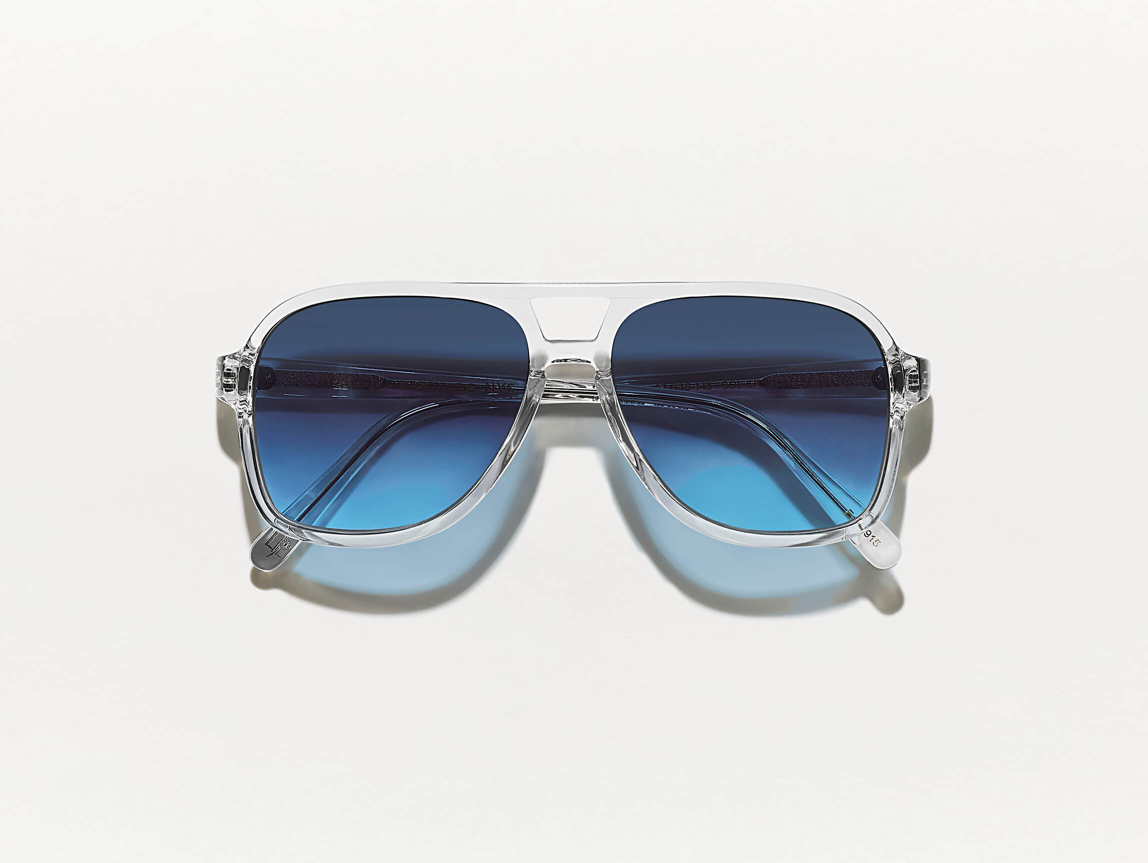 The SHEISTER SUN in Crystal with Denim Blue Tinted Lenses
