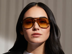Model is wearing The SHEISTER SUN in Bamboo in size 57 with Chestnut Fade Tinted Lenses