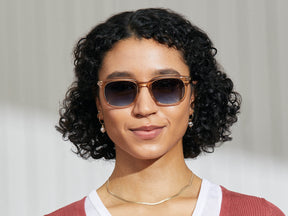Model is wearing The SHIDDOCK SUN in Cinnamon in size 52 with Denim Blue Tinted Lenses