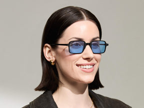 Model is wearing The SHINDIG Black in size 50 with Celebrity Blue Tinted Lenses
