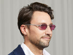 Model is wearing The SHMOOZ SUN in Silver in size 48 with Purple Nurple Tinted Lenses