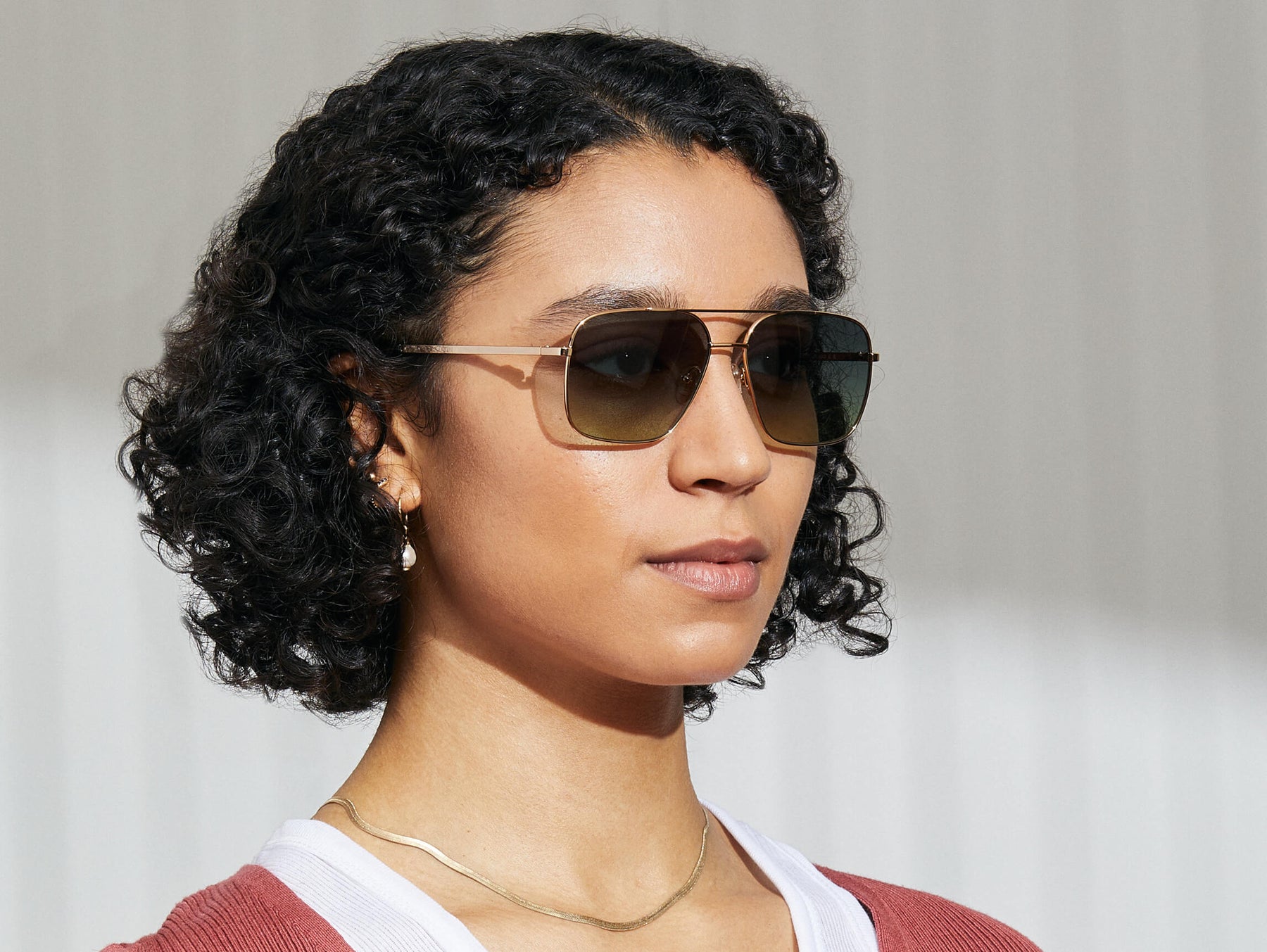 Model is wearing The SHTARKER in size 57 in Gold with Forest Wood Tinted Lenses