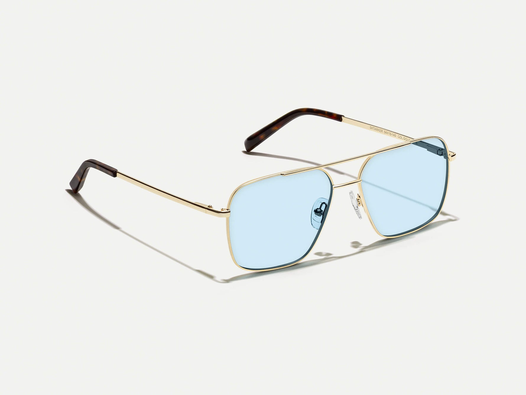 The SHTARKER in Gold with Bel Air Blue Tinted Lenses
