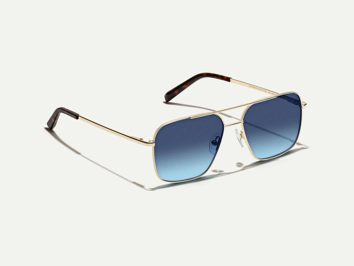 The SHTARKER in Gold with Denim Blue Tinted Lenses