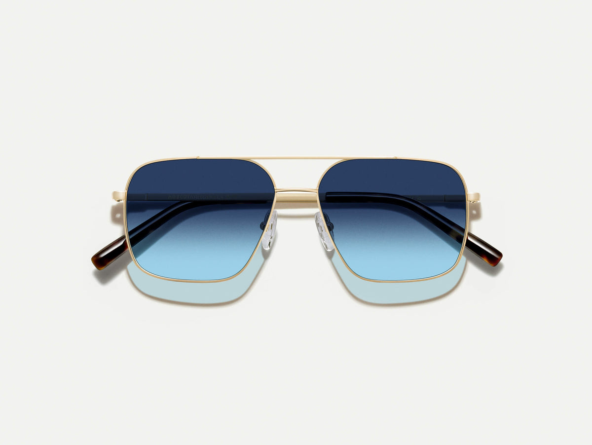 The SHTARKER in Gold with Denim Blue Tinted Lenses