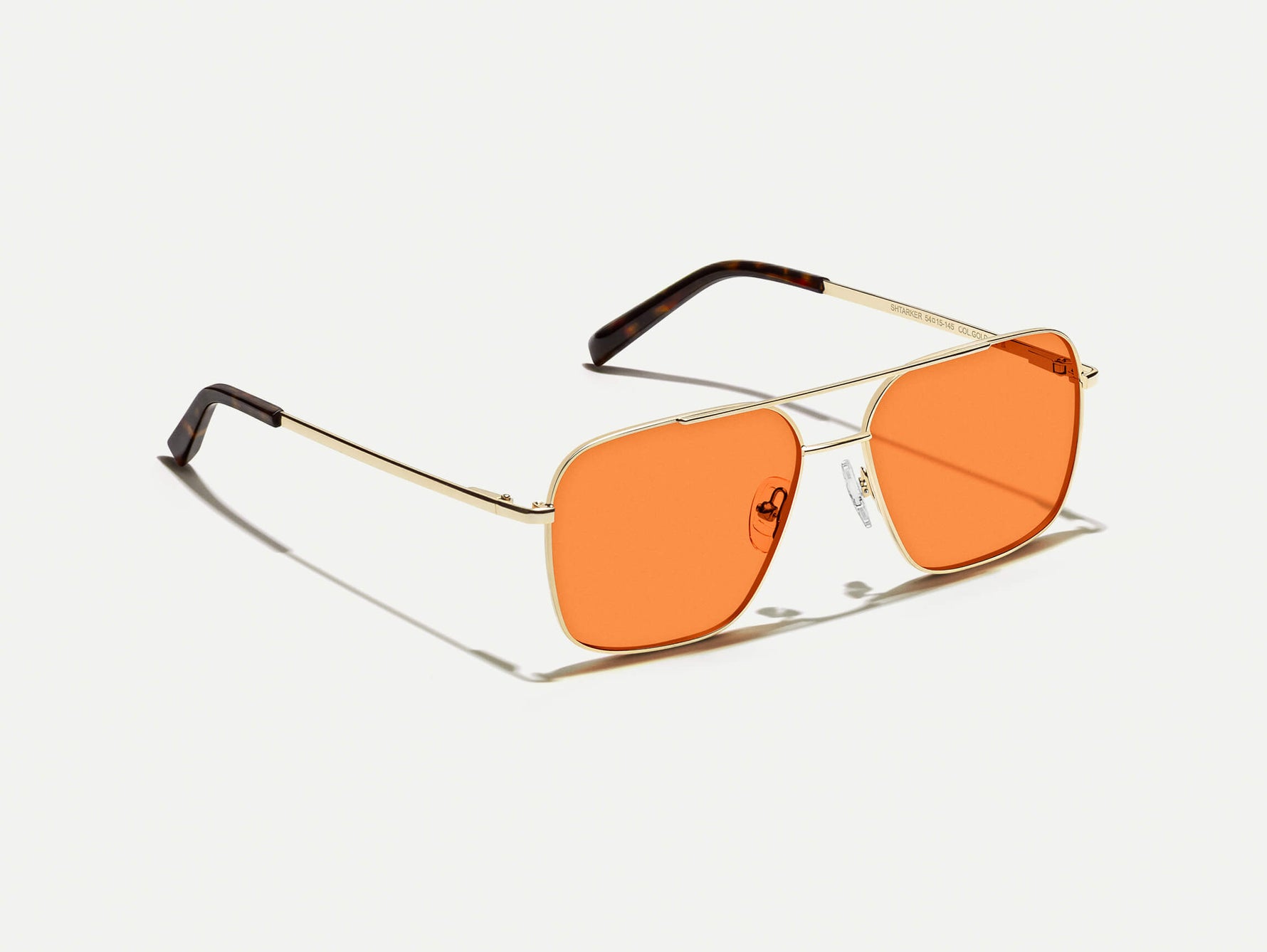 The SHTARKER in Gold with Woodstock Orange Tinted Lenses