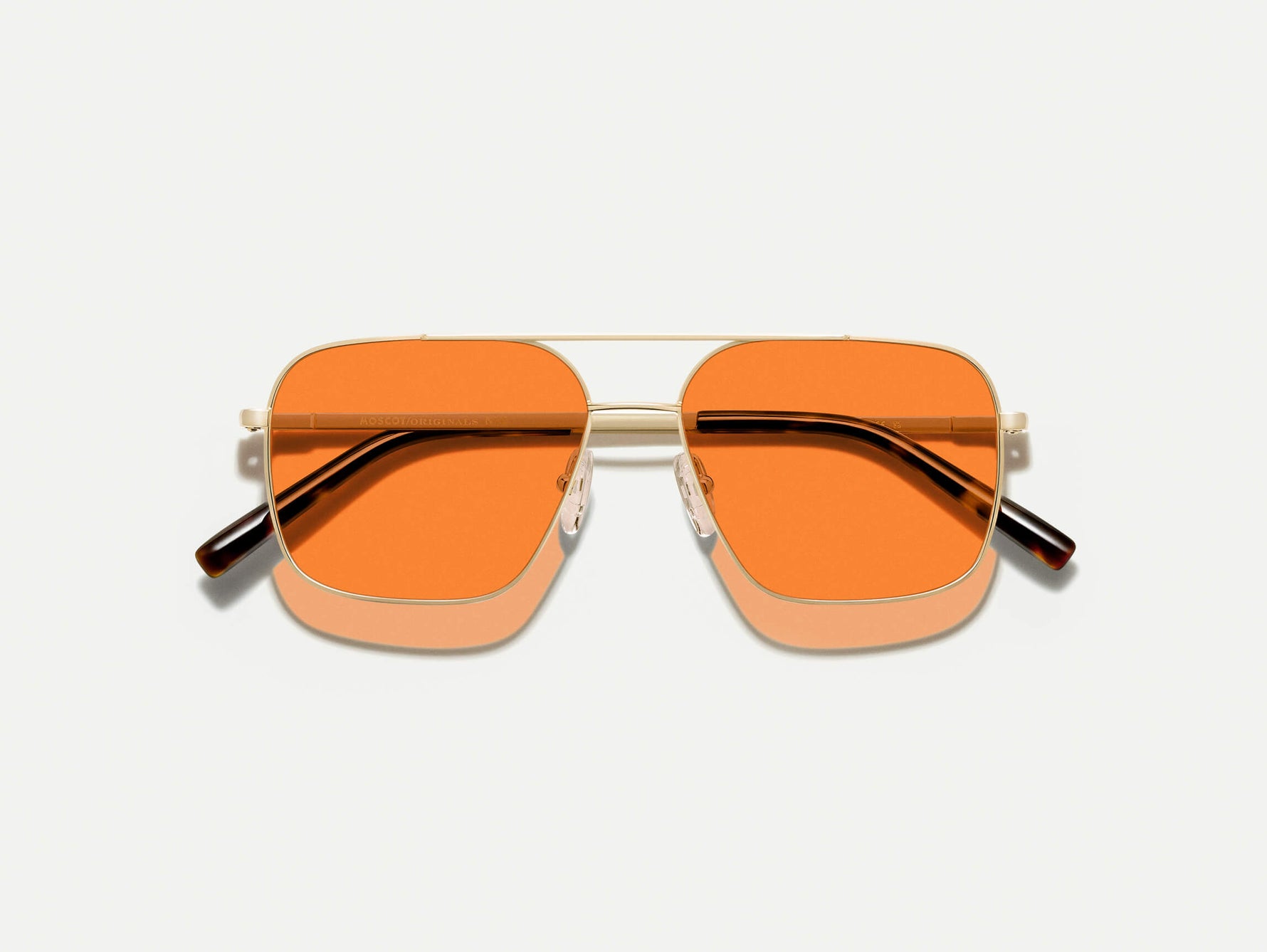 The SHTARKER in Gold with Woodstock Orange Tinted Lenses
