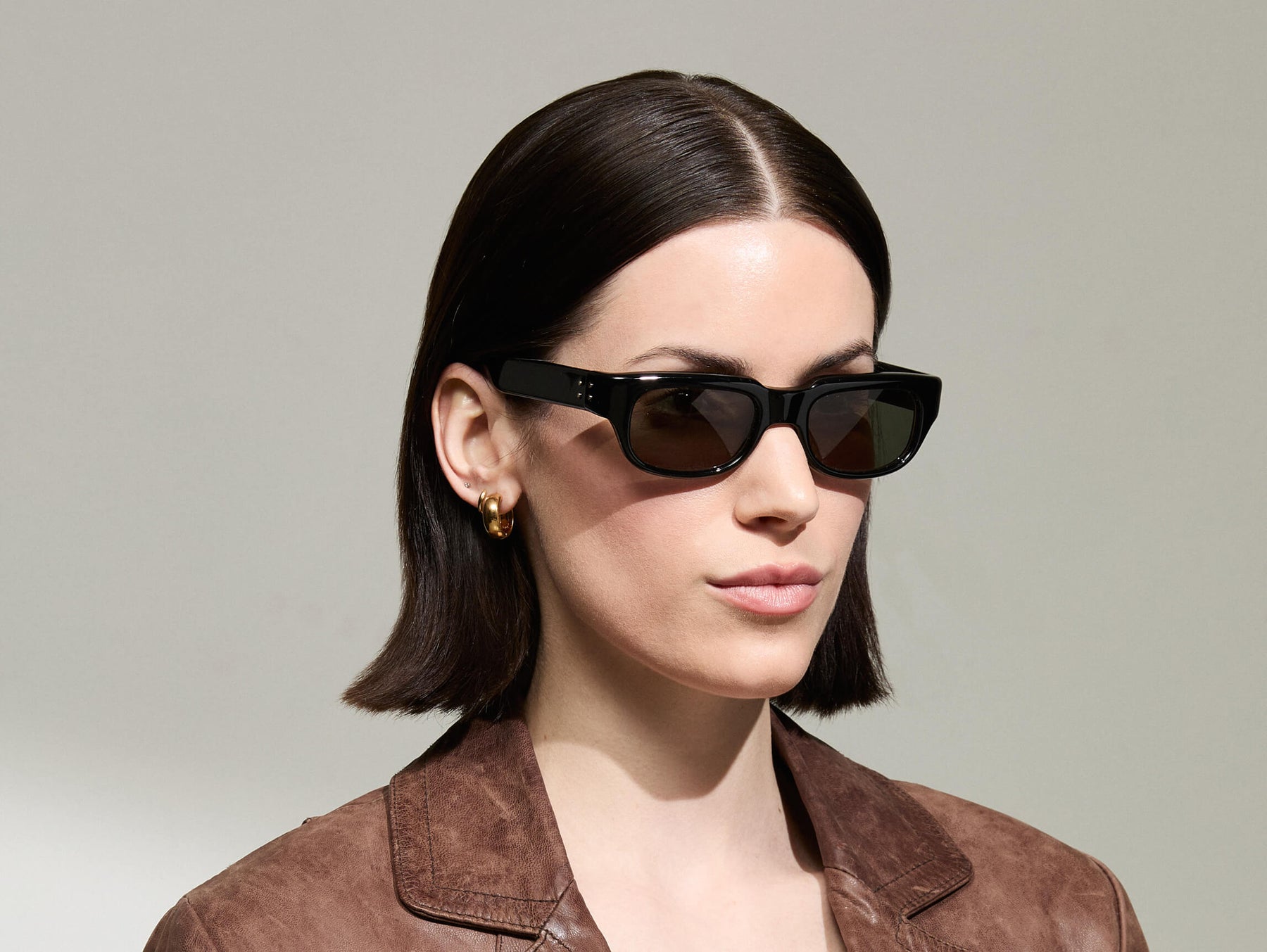 Model is wearing The SHTUP SUN in size 51 in Black with G-15 Tinted Lenses