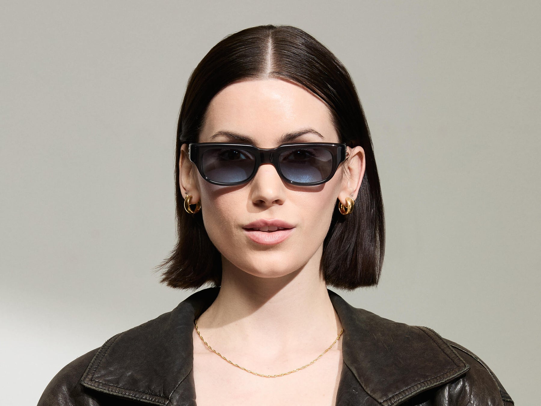 Model is wearing The SHTUP SUN in size 51 in Grey with Denim Blue Tinted Lenses