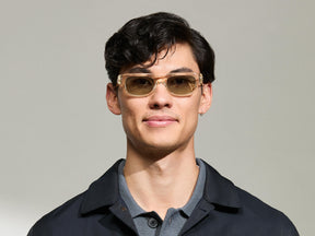 Model is wearing The SHTUP SUN in size 51 in Flesh with Forest Wood Tinted Lenses