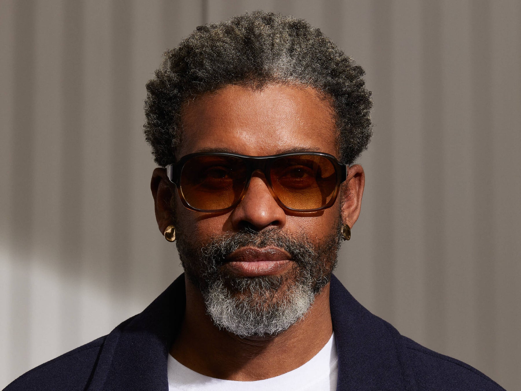 Model is wearing The SHVITZ SUN in Grey-Brown Fade in size 57 with Chestnut Fade Tinted Lenses