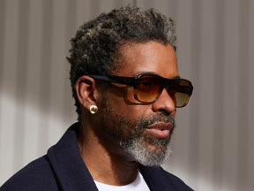 Model is wearing The SHVITZ SUN in Grey-Brown Fade in size 57 with Chestnut Fade Tinted Lenses