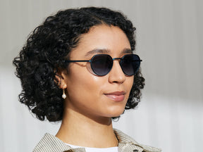Model is wearing The SMENDRIK SUN in Navy in size 51 with Denim Blue Tinted Lenses