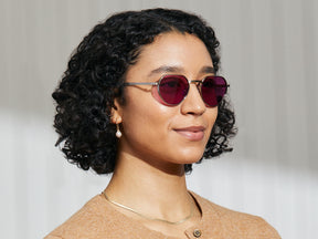 Model is wearing The SMENDRIK SUN in Silver in size 51 with Purple Nurple Tinted Lenses