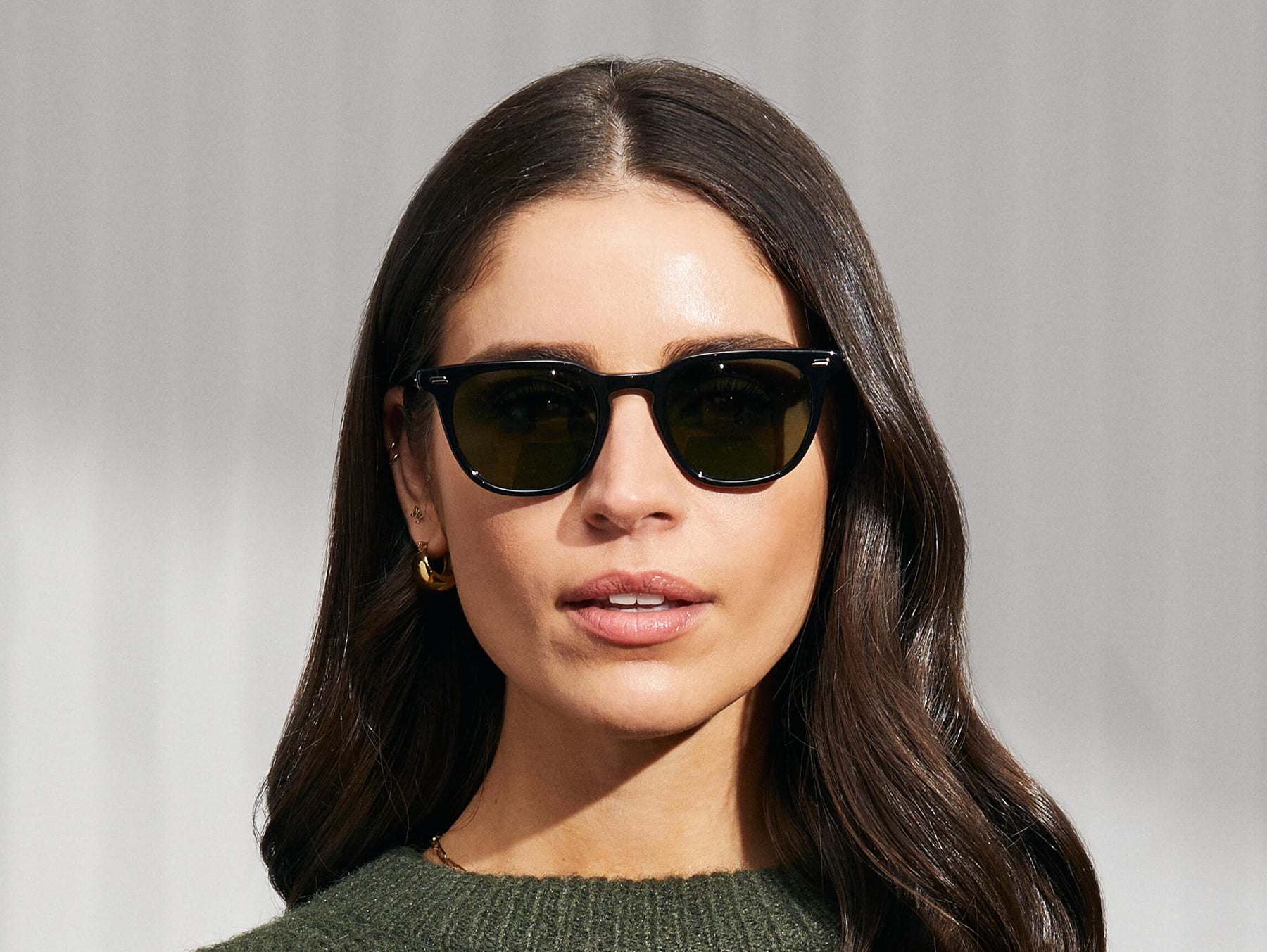 Model is wearing The TATAH SUN in Black in size 50 with G-15 Glass Lenses