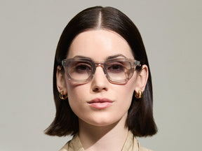 Model is wearing The TELENA in Grey/Light Grey in size 47 with American Grey Fade Tinted Lenses