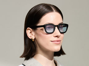 The Model is wearing The TELENA in Black in Size 44 with Bel Air Blue Tinted Lenses