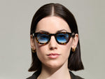 Model is wearing The TELENA  in Tortoise/Black in size 44 with Broadway Blue Tinted Lenses