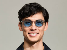 Model is wearing The TELENA in Grey/Light Grey in size 47 with Celebrity Blue Tinted Lenses