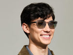 Model is wearing The TELENA in Grey/Light Grey in size 47 with Forest Wood Tinted Lenses