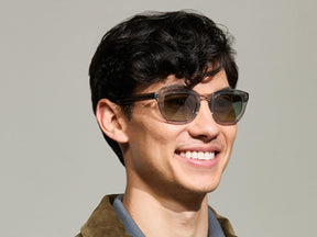 Model is wearing The TELENA in Grey/Light Grey in size 47 with Forest Wood Tinted Lenses