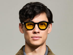 Model is wearing The TELENA in Black in size 47 with Mellow Yellow Tinted Lenses