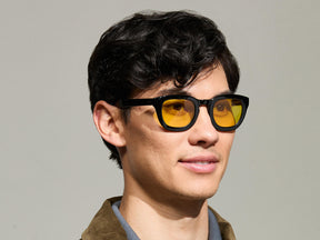 Model is wearing The TELENA in Black in size 47 with Mellow Yellow Tinted Lenses