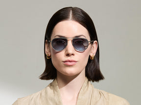 Model is wearing The TRAIF SUN in size 52 in Light Blue with Denim Blue Tinted Lenses