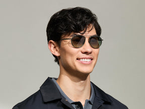 Model is wearing The TRAIF SUN in size 52 in Pine with Forest Wood Tinted Lenses