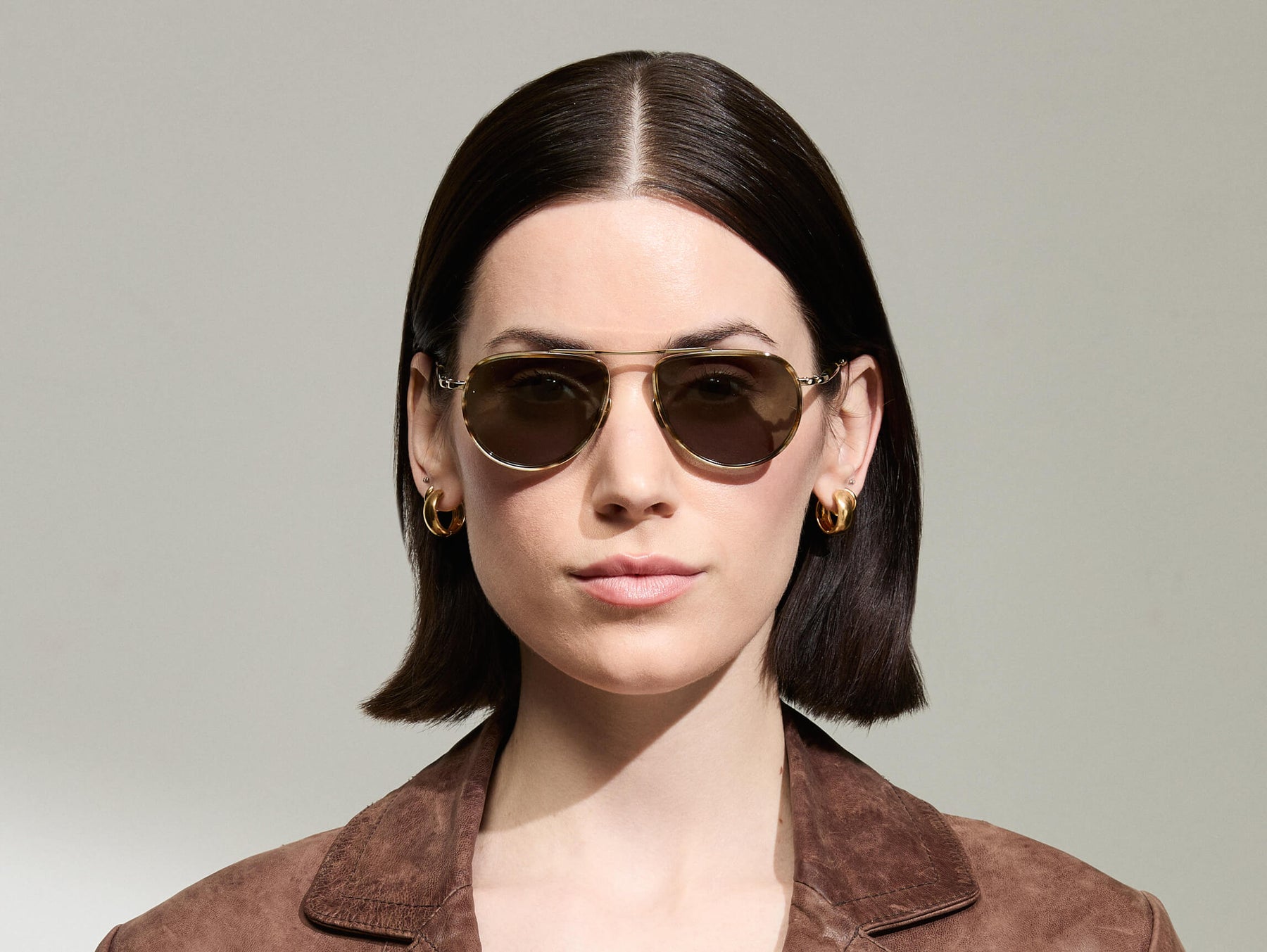 Model is wearing The TRAIF SUN in size 52 in Bamboo with G-15 Tinted Lenses
