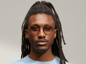 Model is wearing The UTZ SUN in size 50 in Pewter with American Grey Fade Tinted Lenses
