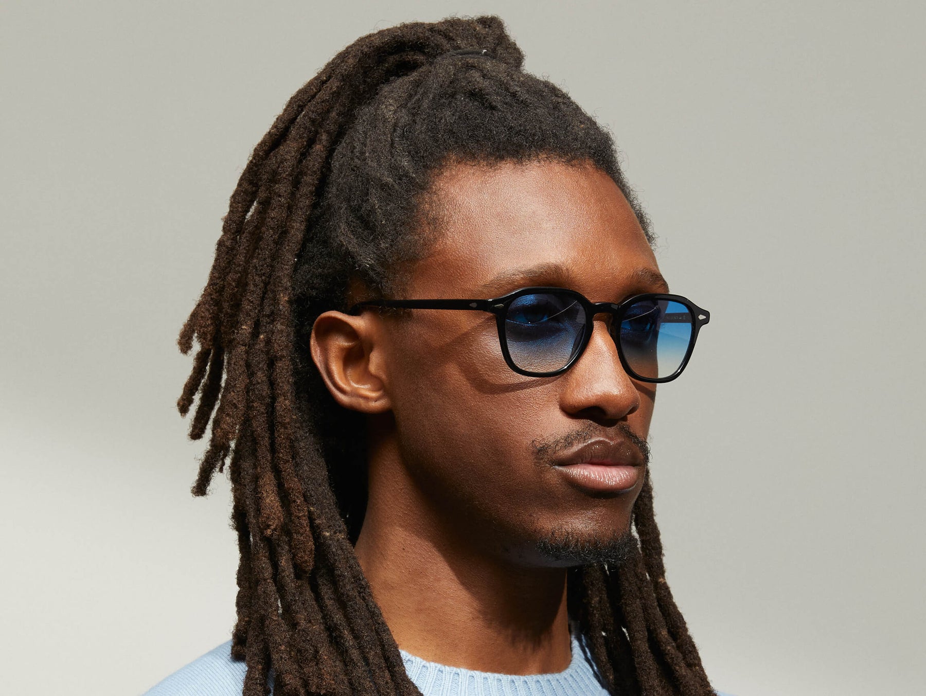 Model is wearing The VANTZ SUN in Black in size 50 with Broadway Blue Fade Tinted Lenses