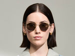 Model is wearing The ZEV SUN in Bamboo in size 49 with G-15 Tinted Lenses