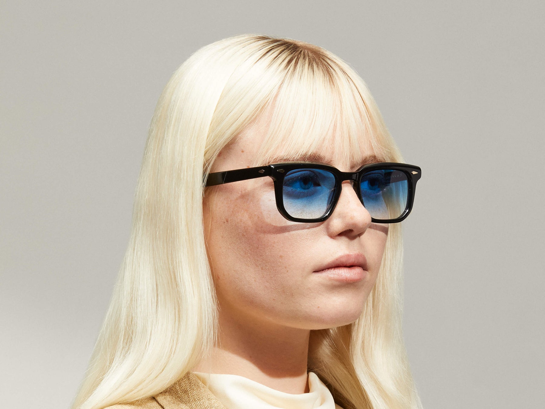Model is wearing The ZISSEL SUN in size 49 in Black with Broadway Blue Tinted Lenses