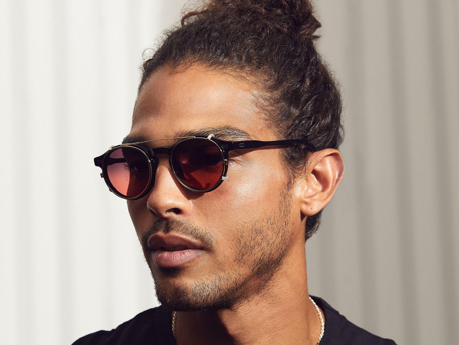 Model is wearing The CLIPZEN in Gold in size 46 with Cabernet Tinted Lenses