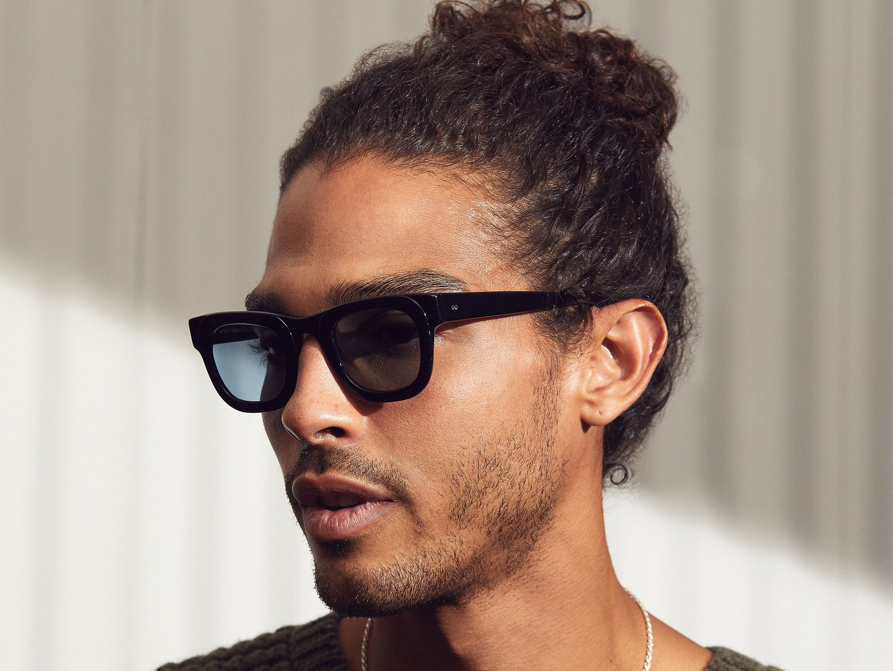 Model is wearing the FRITZ SUN in Black in size 44 with DG-37 Blue Glass Lenses