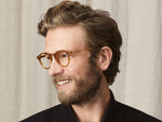 Model is wearing The MILTZEN in Blonde in size 46 with Blue Protect Lenses