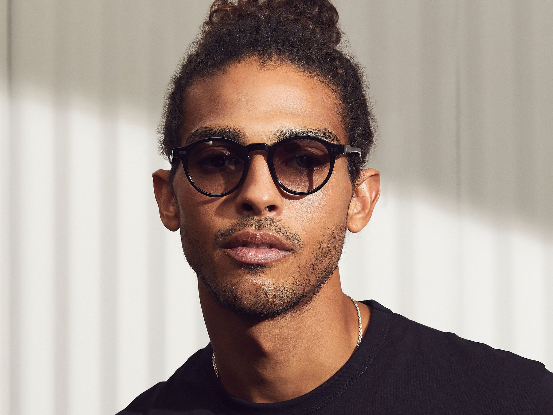Model is wearing The MILTZEN in Black in size 46 with American Grey Fade Tinted Lenses