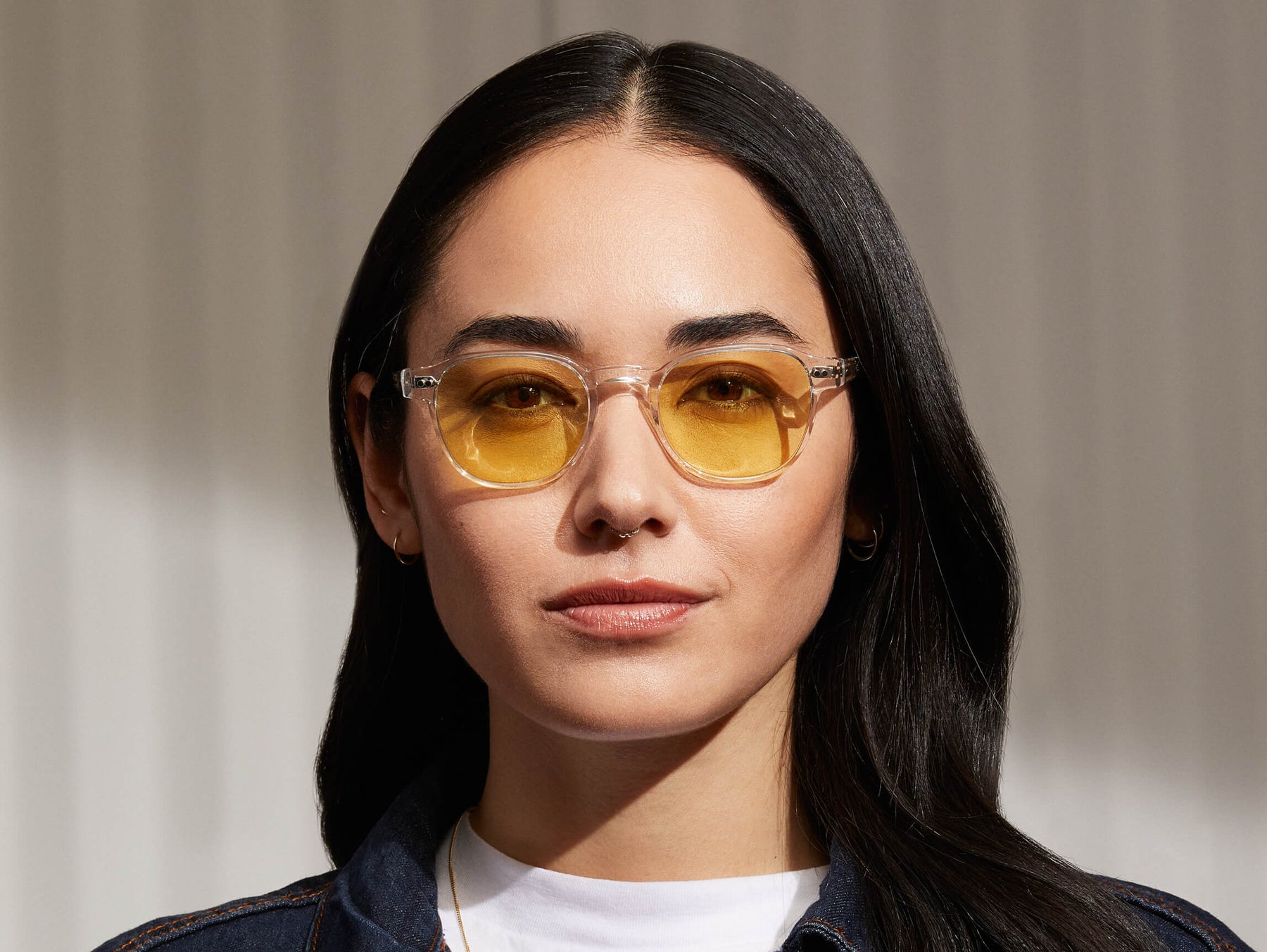 Model is wearing The ARTHUR in Crystal in size 48 with Pastel Yellow Tinted Lenses