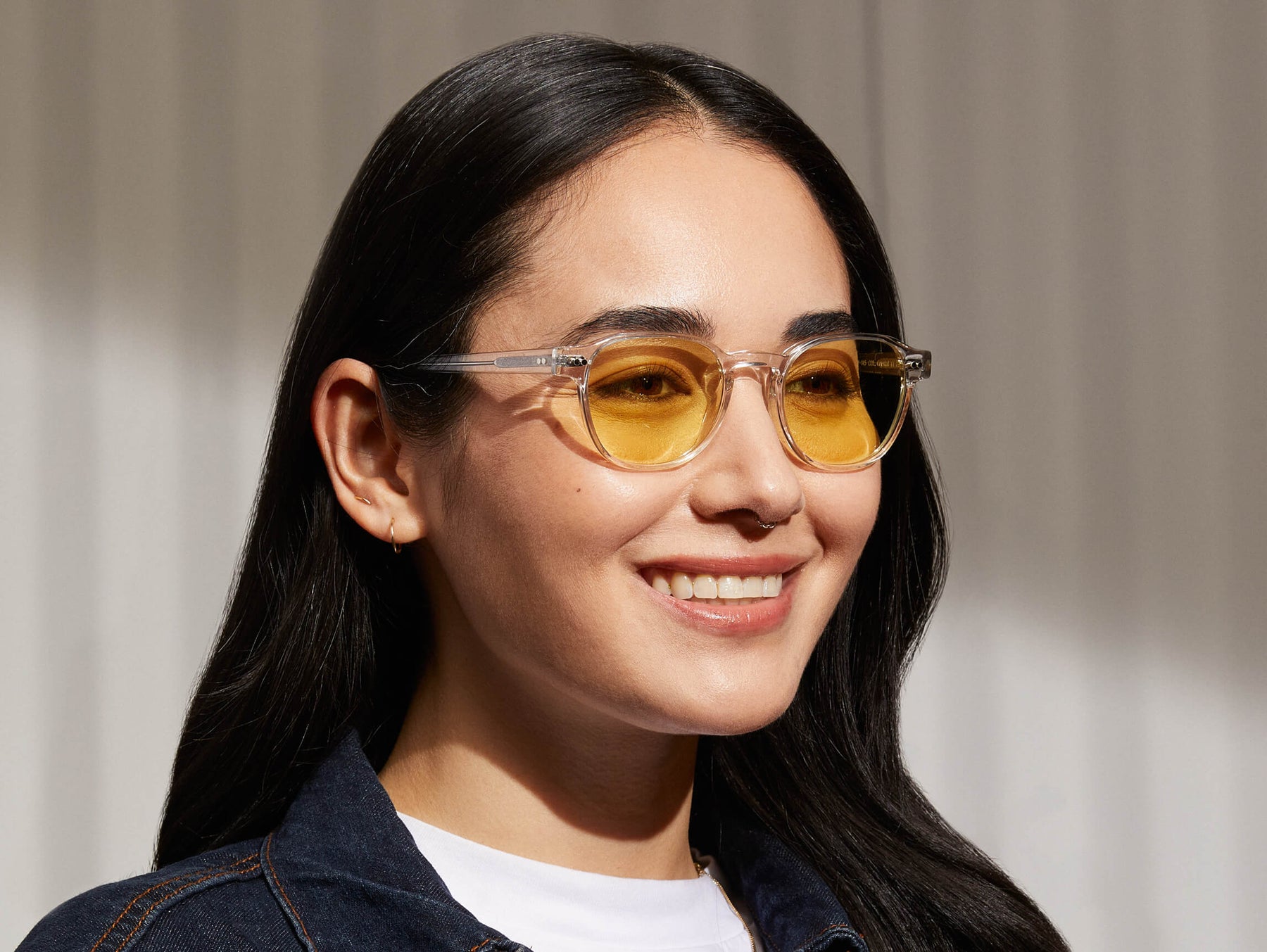 Model is wearing The ARTHUR in Crystal in size 48 with Pastel Yellow Tinted Lenses