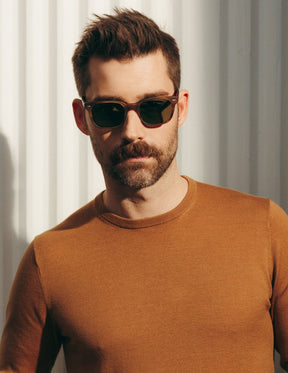 Model is wearing The BOYCHIK SUN in Matte Dark Blonde in size 52 with Calibar Green Glass Lenses