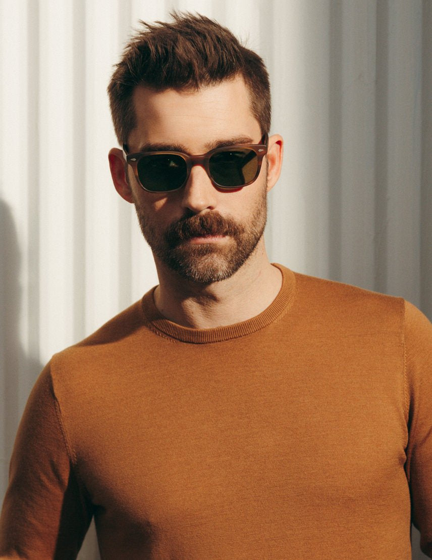 Model is wearing The BOYCHIK SUN in Matte Dark Blonde in size 52 with Calibar Green Glass Lenses