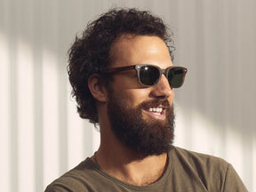 Model is wearing The BOYCHIK SUN in Matte Dark Blonde in size 52 with Calibar Green Glass Lenses