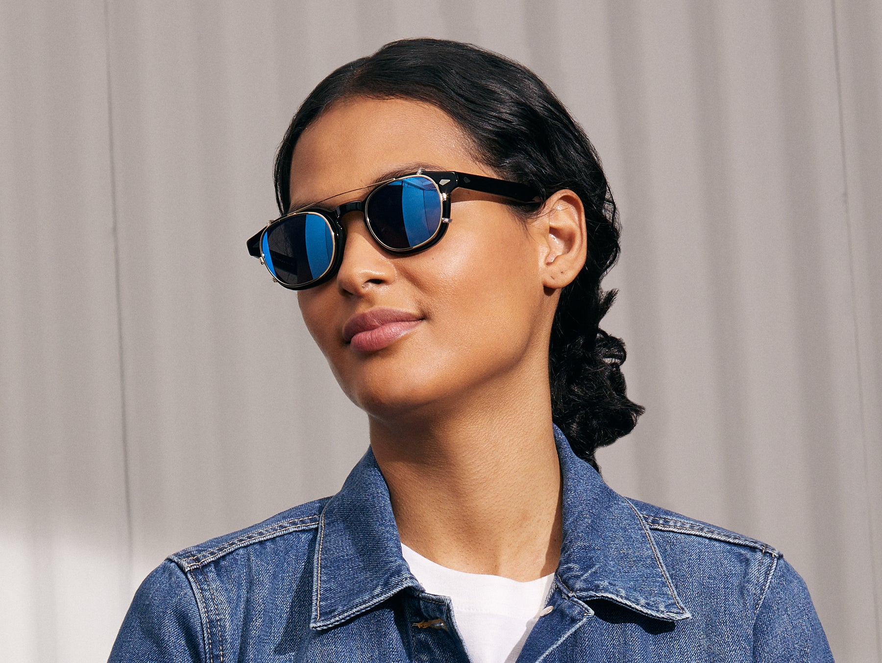 Model is wearing The CLIPTOSH in Gold in size 46 with Blue Mirror Lenses