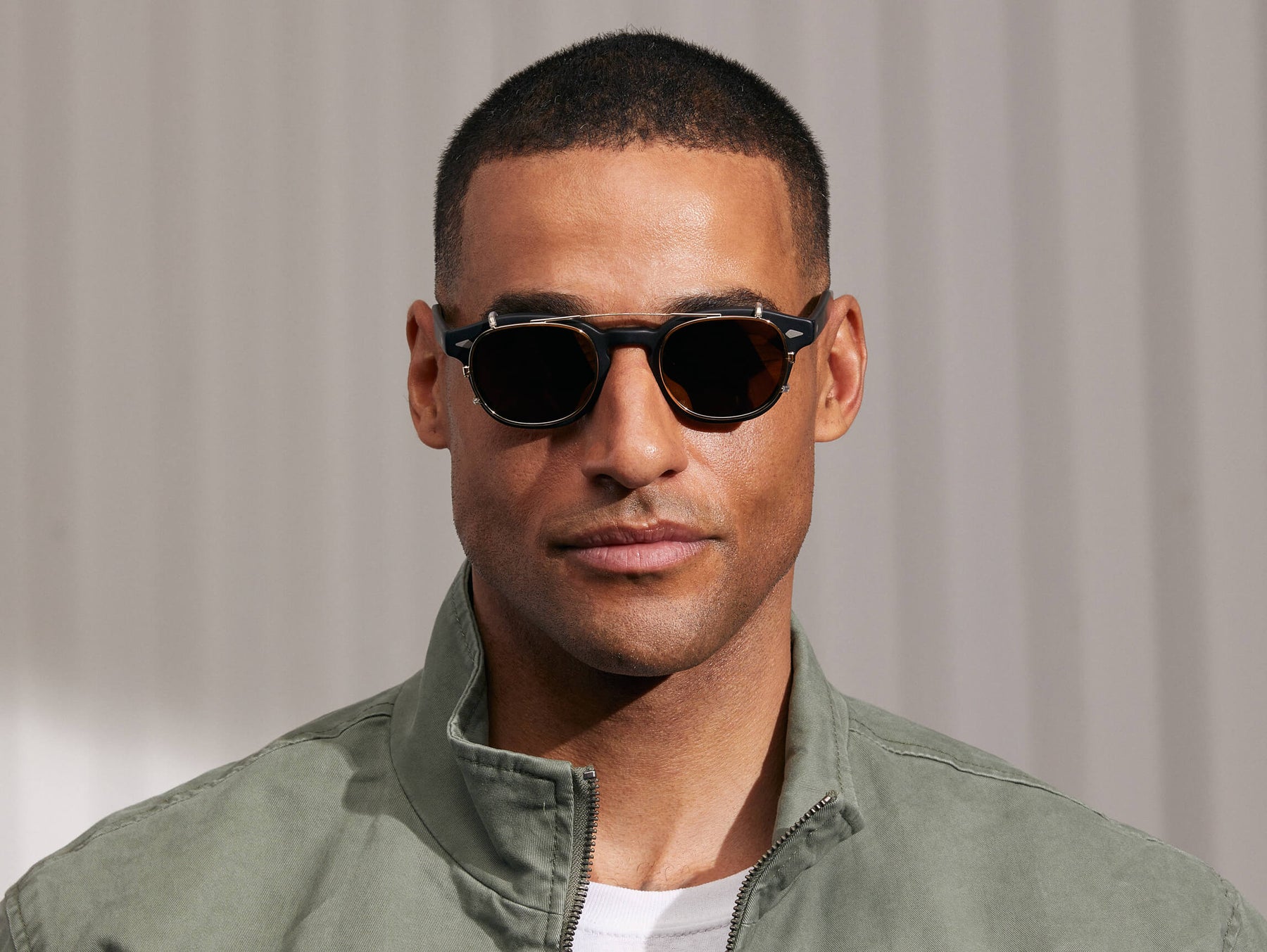 Model is wearing The CLIPTOSH in Gold in size 49 with Gold Mirror Lenses