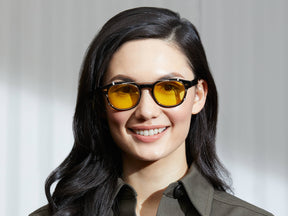 Model is wearing The CLIPTOSH in Gold in size 46 with Mellow Yellow Tinted Lenses